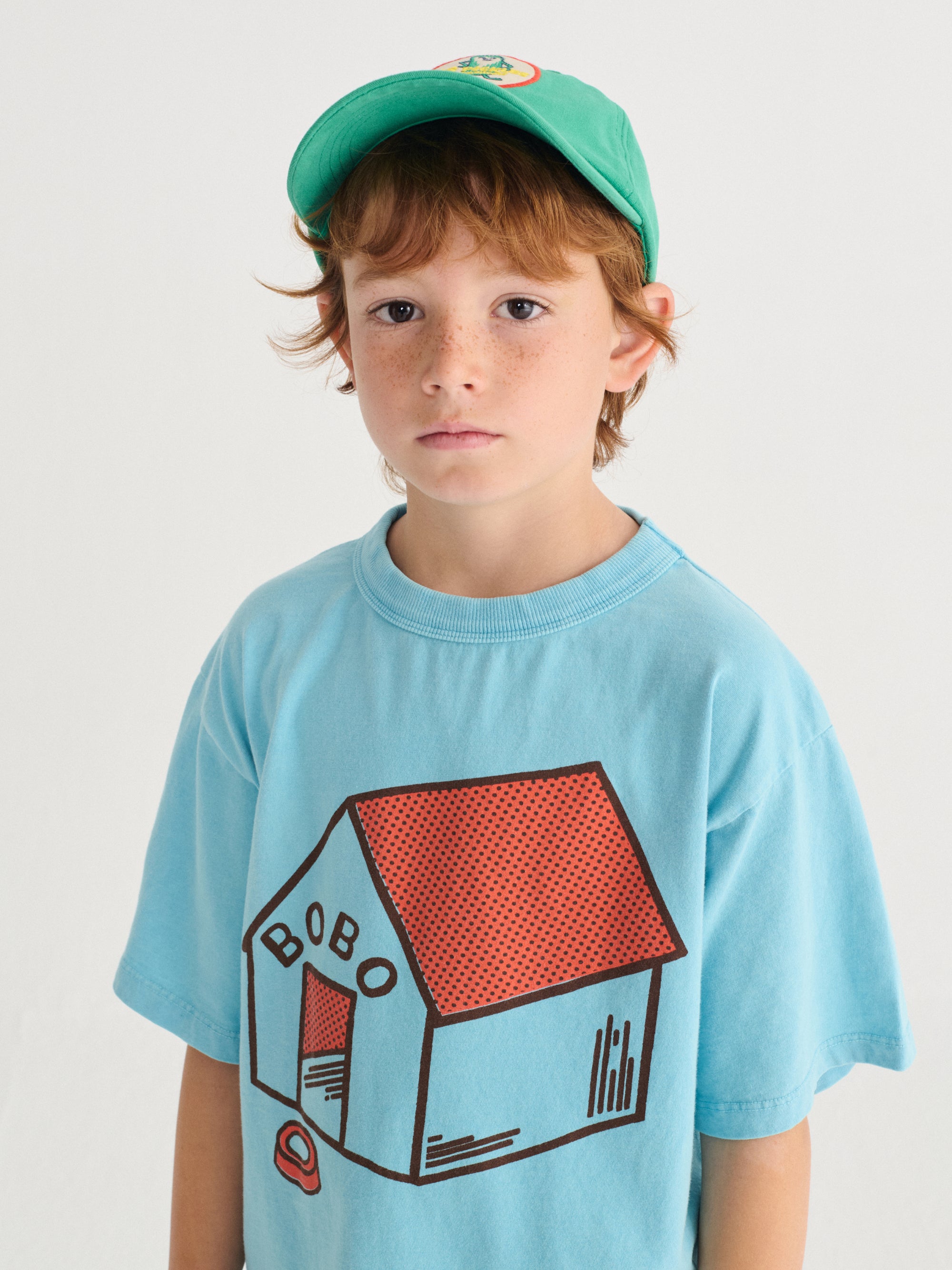 Light blue T-shirt with "Pickles Is At Home" print