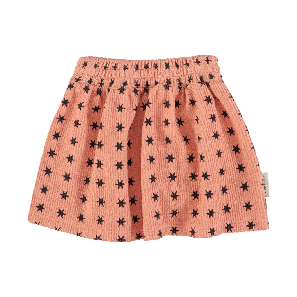 Jupe courte rose à étoiles noires